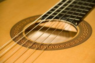 Frettes d'une touche de guitare classique vues sous une lumière rasante